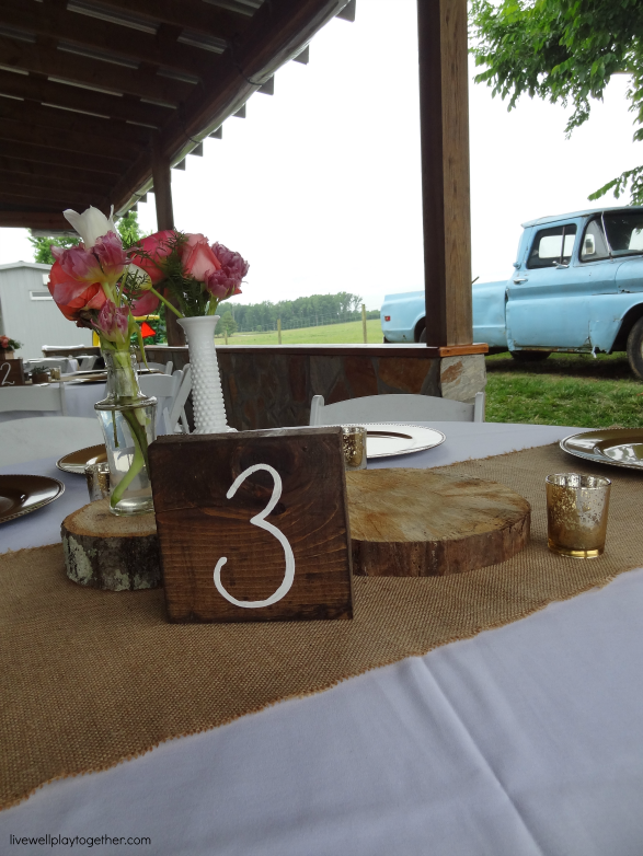 DIY Wedding Table Numbers - Simply stain a block of wood with dark stain and write numbers with white or metalic paint marker