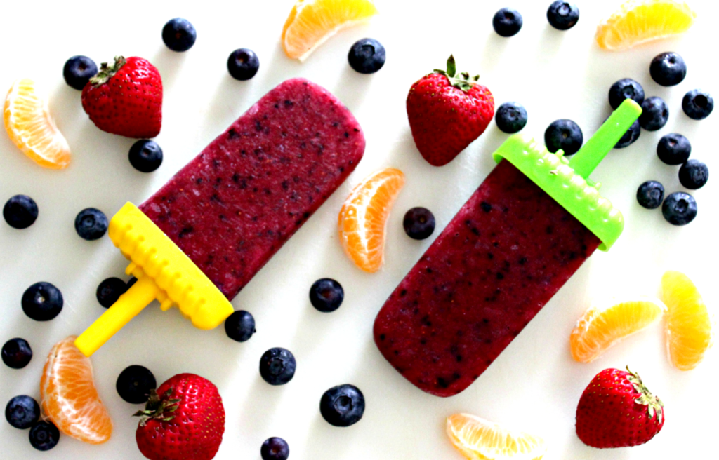 Homemade Strawberry-Blueberry Popsicles from Live Well Play Together. These homemade mixed berry pops are the perfect treat to cool off during the summer. Quick, healthy, and kid-friendly! #popsicles #frozenpops #icepops #healthysnacks #summersnacks #summerfood #strawberries #blueberries #kidfriendlyrecipes