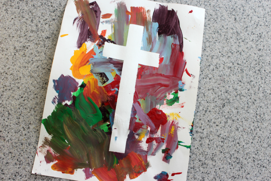 This tape resist cross is an easy & fun Easter craft for kids.  It's the perfect Easter craft for Sunday school, or at home.  Just 4 supplies and easy to set up; i's a great way to teach children about Easter!  #Easetercrafts #Eastercraftideas #resistartideas #taperesistart #taperesistcross #eastercross