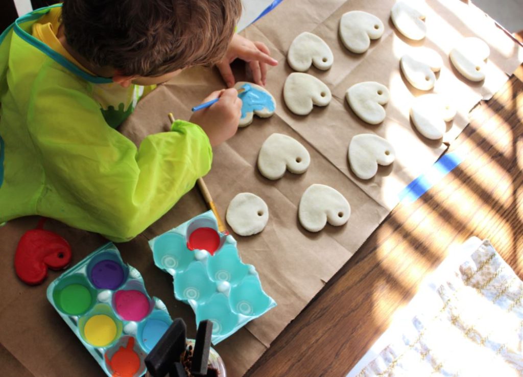 Painting heart shaped salt dough ornaments with acrylic paint