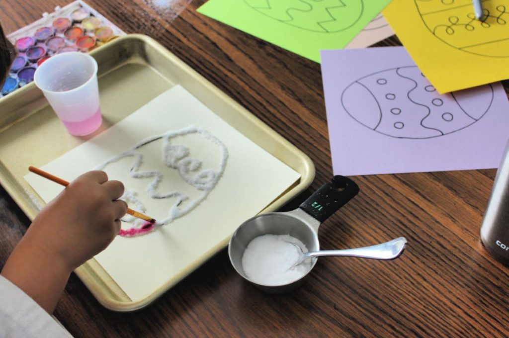 Painting with water color paint and salt for a fun Easter craft for kids