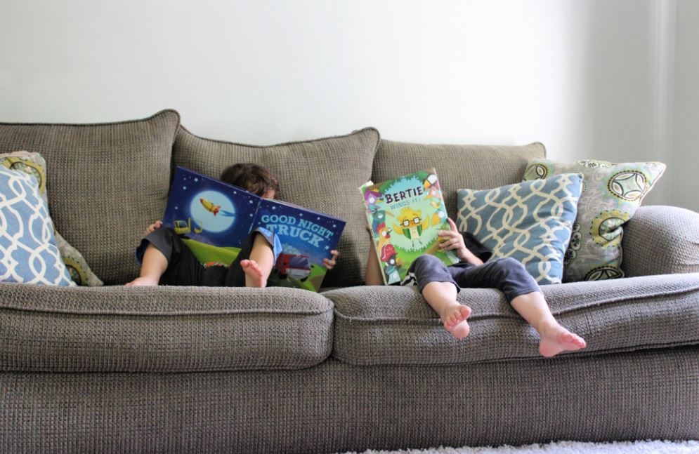 Kids reading picture books on the couch. Bookroo subscription box for kids review