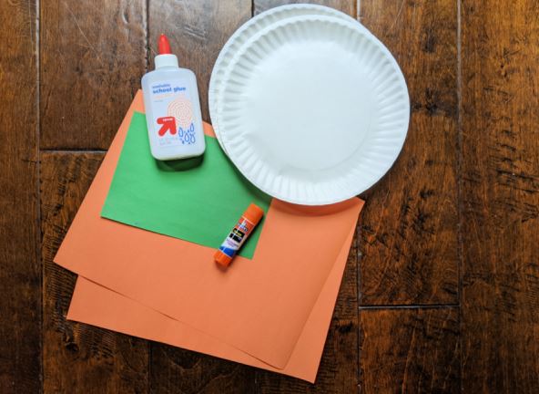 Craft supplies for making a paper plate pumpkin