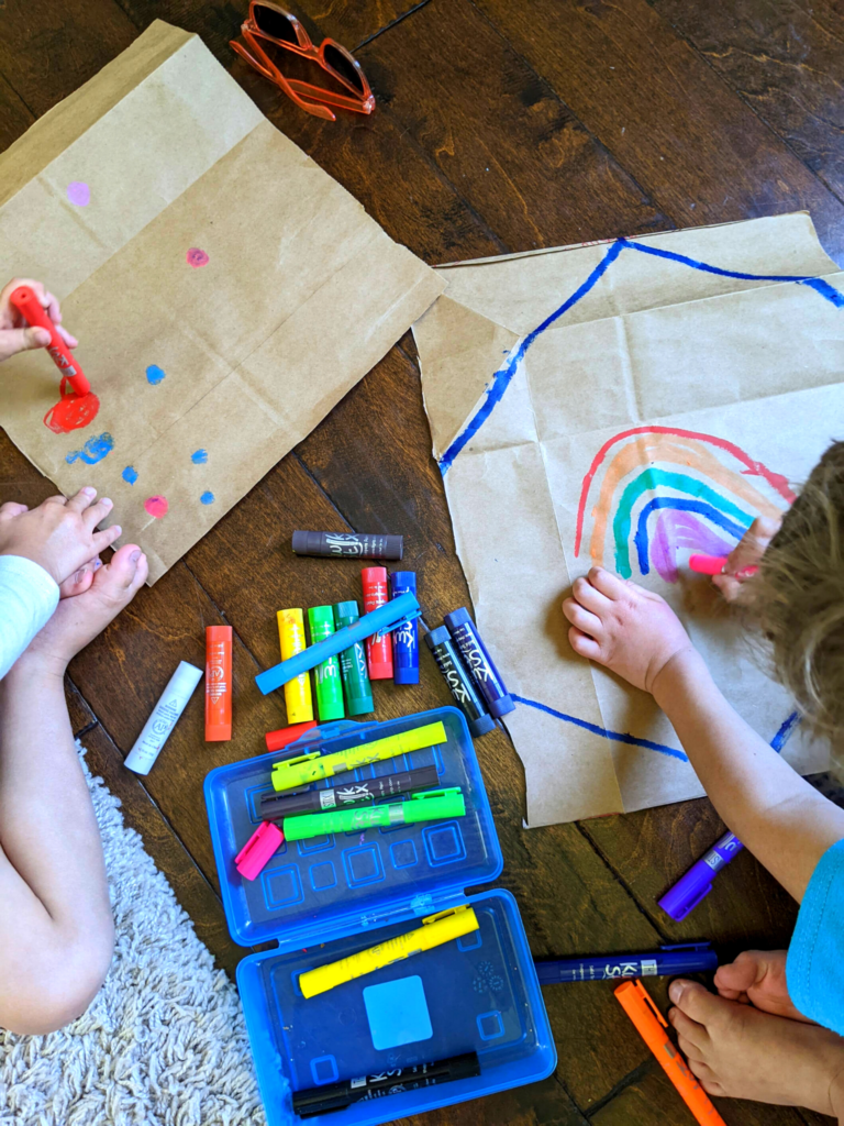 Kids painting wrapping paper with Kwik Stix Tempera Paint Sticks